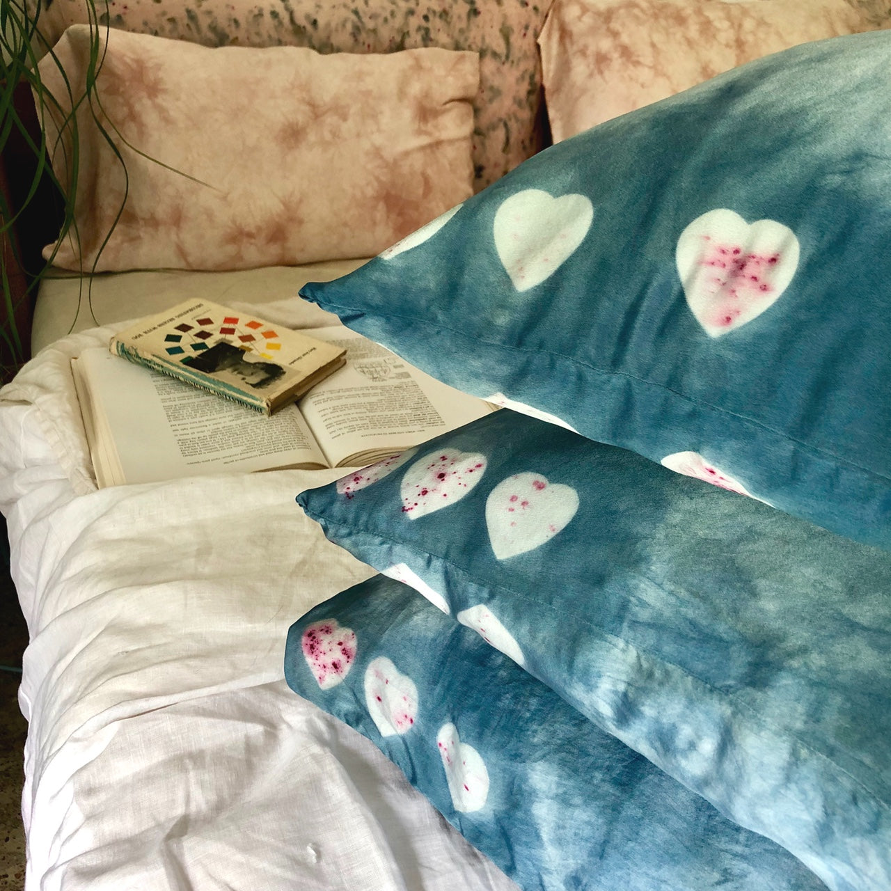 stack of indigo dyed silk pillowcases with heart pattern