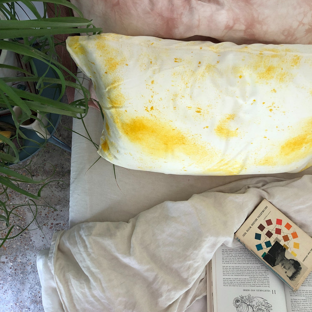 Yellow and white Silk Pillowcase Natural Dye on bed