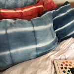 Indigo Stripe Silk Pillowcase on bed with madder red ones