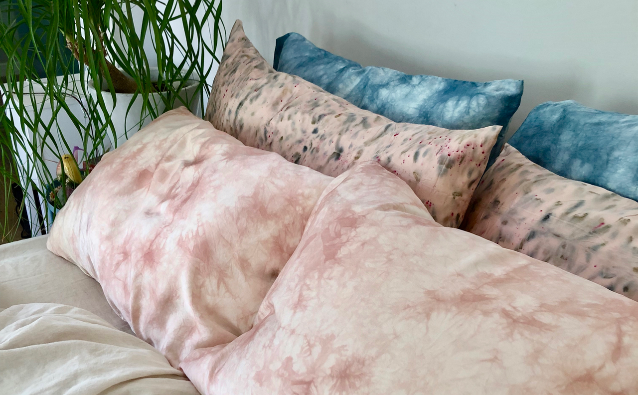 Six Silk Pillowcases on a bed all naturally dyed four pink two blue