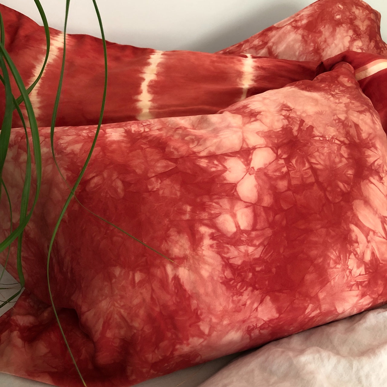 Naturally Dyed with Madder Red Silk Pillowcases propped up on bed