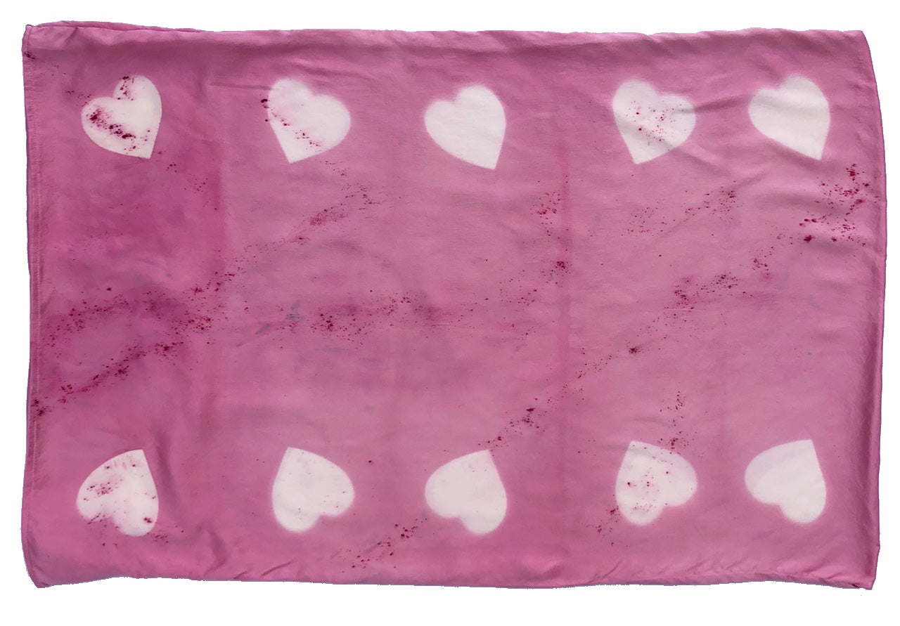Naturally dyed pink silk pillowcase with white hearts flat view