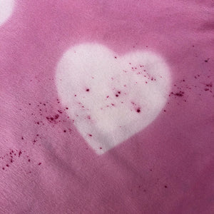detail of pink silk pillowcase with white hearts showing hot pink  sprinkle